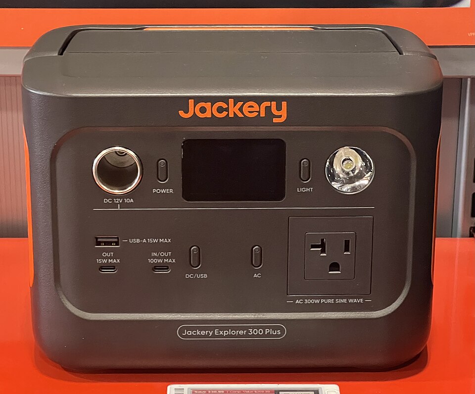 A dark gray Jackery Explorer 300 Plus power station with a display, USB ports and an AC outlet on the front, for storm prep in Pensacola, FL